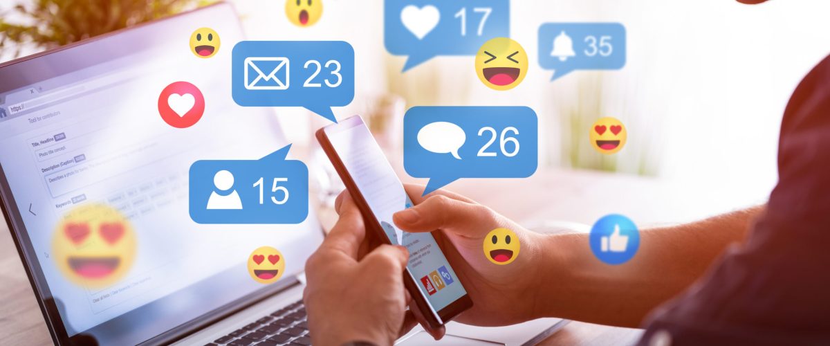 Like and share social media. Hands holding smartphone with social media network icons. Marketing concept.